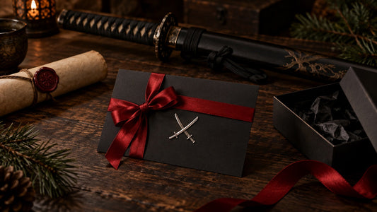 The Sword Stall Gift Card - a black gift card tied with a red ribbon beside a katana and a sealed scroll